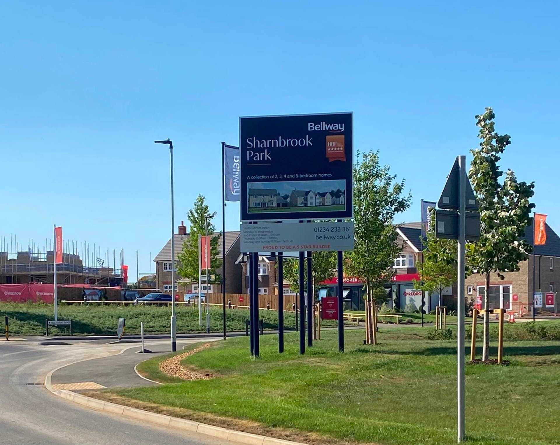 Bellway Sharnbrook Park development sign with new houses under construction